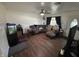Cozy living room featuring hardwood floors, a ceiling fan, and ample room for entertaining at 2015 Rosewood Dr, Anderson, IN 46011