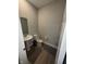 Bathroom featuring a pedestal sink, toilet, and wood floors with rugs at 2263 S Carlota Dr, New Palestine, IN 46163