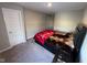 Bedroom showcasing a platform bed, closet doors, and a neutral wall color at 2263 S Carlota Dr, New Palestine, IN 46163