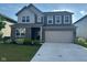 Beautiful two-story home with brick and siding, lush lawn, and a two-car garage at 2263 S Carlota Dr, New Palestine, IN 46163