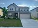 Beautiful two-story home with brick and siding, lush lawn, and a two-car garage at 2263 S Carlota Dr, New Palestine, IN 46163