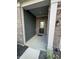 Front entrance showcasing the black door, brick facade, and covered porch of the home at 2263 S Carlota Dr, New Palestine, IN 46163