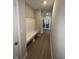 Hallway featuring wood floors, a coat rack, and decorative doors at the end at 2263 S Carlota Dr, New Palestine, IN 46163