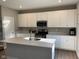 Bright kitchen featuring a center island, modern appliances, and white cabinetry at 2263 S Carlota Dr, New Palestine, IN 46163