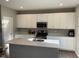 Bright kitchen featuring a center island, modern appliances, and white cabinetry at 2263 S Carlota Dr, New Palestine, IN 46163