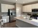 Bright kitchen featuring stainless steel appliances, a center island with sink, and modern cabinetry at 2263 S Carlota Dr, New Palestine, IN 46163