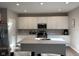 Bright kitchen featuring a center island, modern appliances, and white cabinetry at 2263 S Carlota Dr, New Palestine, IN 46163