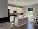 Bright kitchen featuring a center island with bar top, stainless steel appliances and modern cabinetry at 2263 S Carlota Dr, New Palestine, IN 46163