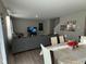 Open-concept living area with a modern table set and a spacious sectional sofa in the background at 2263 S Carlota Dr, New Palestine, IN 46163