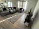 Comfortable living room featuring a large sectional sofa, area rug, and modern entertainment setup at 2263 S Carlota Dr, New Palestine, IN 46163