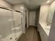 The main bathroom has a quartz counter top, a single-sink vanity, tile floors, and a glass-enclosed shower at 2263 S Carlota Dr, New Palestine, IN 46163