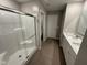 This is the main bathroom with a glass shower, quartz countertop, and single sink vanity at 2263 S Carlota Dr, New Palestine, IN 46163