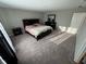 This is the main bedroom with a queen bed, soft carpet, and direct access to the main bathroom at 2263 S Carlota Dr, New Palestine, IN 46163