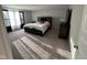 This main bedroom has a queen bed, soft carpet, and a large window with decorative curtains at 2263 S Carlota Dr, New Palestine, IN 46163