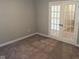 Empty room featuring neutral walls, plush carpet, and glass-paned double doors at 2263 S Carlota Dr, New Palestine, IN 46163