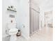Clean bathroom with a toilet, shower with curtain, and neutral decor at 2353 E 10Th St, Anderson, IN 46012