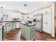 This kitchen features stainless steel appliances, white cabinets, dark countertops and hardwood flooring at 2353 E 10Th St, Anderson, IN 46012
