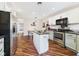 Spacious kitchen featuring stainless steel appliances, white cabinets, dark countertops, and a central island at 2353 E 10Th St, Anderson, IN 46012