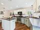 Modern kitchen features stainless steel appliances, a kitchen island and hardwood flooring with light countertops at 2353 E 10Th St, Anderson, IN 46012
