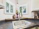 Close-up of kitchen sink area with stainless steel faucet and sink, bright windows, and dark countertops at 2353 E 10Th St, Anderson, IN 46012
