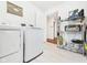Practical laundry room featuring modern washer and dryer, plus storage shelves at 2353 E 10Th St, Anderson, IN 46012