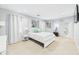 Bright main bedroom with large windows, plush carpet, and serene decor at 2353 E 10Th St, Anderson, IN 46012