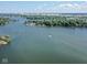 Beautiful aerial view of a lake with scattered homes nestled among lush green trees, offering serene waterfront living at 247 Verdant Dr, Cicero, IN 46034