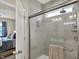 Modern bathroom with a glass-enclosed shower, sleek fixtures, and neutral tile at 247 Verdant Dr, Cicero, IN 46034