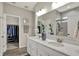 Well-lit bathroom with double vanity, a large mirror, and a walk-in closet nearby at 247 Verdant Dr, Cicero, IN 46034