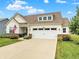 Inviting single-Gathering home boasting a manicured lawn, complemented by an attached two-car garage at 247 Verdant Dr, Cicero, IN 46034