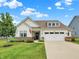 Charming one-story home with a well-manicured lawn, beautiful landscaping, and an attached two-car garage at 247 Verdant Dr, Cicero, IN 46034