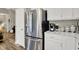 Bright kitchen area with stainless steel refrigerator and white cabinets at 247 Verdant Dr, Cicero, IN 46034