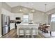 Bright kitchen with white cabinets, pendant lighting, and stainless steel appliances at 247 Verdant Dr, Cicero, IN 46034