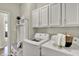 Well-lit laundry room offers modern appliances, built-in storage, and a comfortable bench at 247 Verdant Dr, Cicero, IN 46034