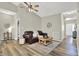 Cozy living room with a dark leather couch, ceiling fan, and neutral decor at 247 Verdant Dr, Cicero, IN 46034