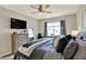 Inviting main bedroom with a ceiling fan, dresser with mirror, and plush bedding at 247 Verdant Dr, Cicero, IN 46034