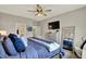 Comfortable main bedroom with a ceiling fan, mounted television, and a dresser with a mirror at 247 Verdant Dr, Cicero, IN 46034