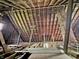 Spacious attic features unfinished flooring and exposed wooden beams at 2606 Raible Ave, Anderson, IN 46011