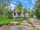 Exterior view of home showcasing the yard and weathered facade at 2606 Raible Ave, Anderson, IN 46011