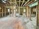 Interior view of a home under renovation, revealing exposed framing and brick at 2606 Raible Ave, Anderson, IN 46011