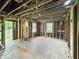Open-concept space featuring exposed framing and natural light, ready for personalized renovation to create a dream living area at 2606 Raible Ave, Anderson, IN 46011
