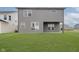 Back of home view shows a green yard, neutral siding, and great window light at 2693 Penn Ave, Plainfield, IN 46168