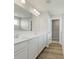 Bathroom featuring dual sinks, white cabinets, and wood-look floors at 2693 Penn Ave, Plainfield, IN 46168