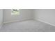 Comfortable bedroom is filled with plush carpet, neutral walls, and a window for natural light at 2693 Penn Ave, Plainfield, IN 46168