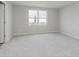 Bedroom featuring gray carpet, window, and closet at 2693 Penn Ave, Plainfield, IN 46168