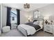 This primary bedroom features soft carpet, an ornate light fixture and comforting colors to help relax and unwind at 2693 Penn Ave, Plainfield, IN 46168