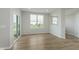 Bright dining room featuring wood floors, large windows, and a sliding glass door at 2693 Penn Ave, Plainfield, IN 46168