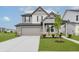 Charming two-story home with a two-car garage, well-manicured lawn, and stylish architectural details at 2693 Penn Ave, Plainfield, IN 46168