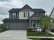 Charming two-story home featuring a two-car garage, landscaped yard, and modern architectural details at 2693 Penn Ave, Plainfield, IN 46168