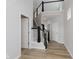 Bright foyer with wood floors, staircase and railing, and white doors and trim at 2693 Penn Ave, Plainfield, IN 46168